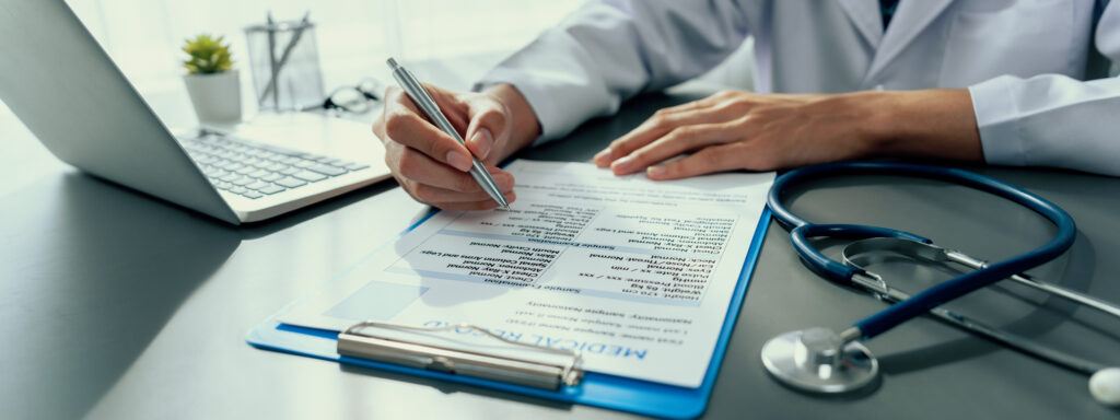 Doctor carefully review detailed medical report with laptop and diagnosing illness for effective healthcare treatment plan for patient in doctor office. Professional medical evaluation. Neoteric